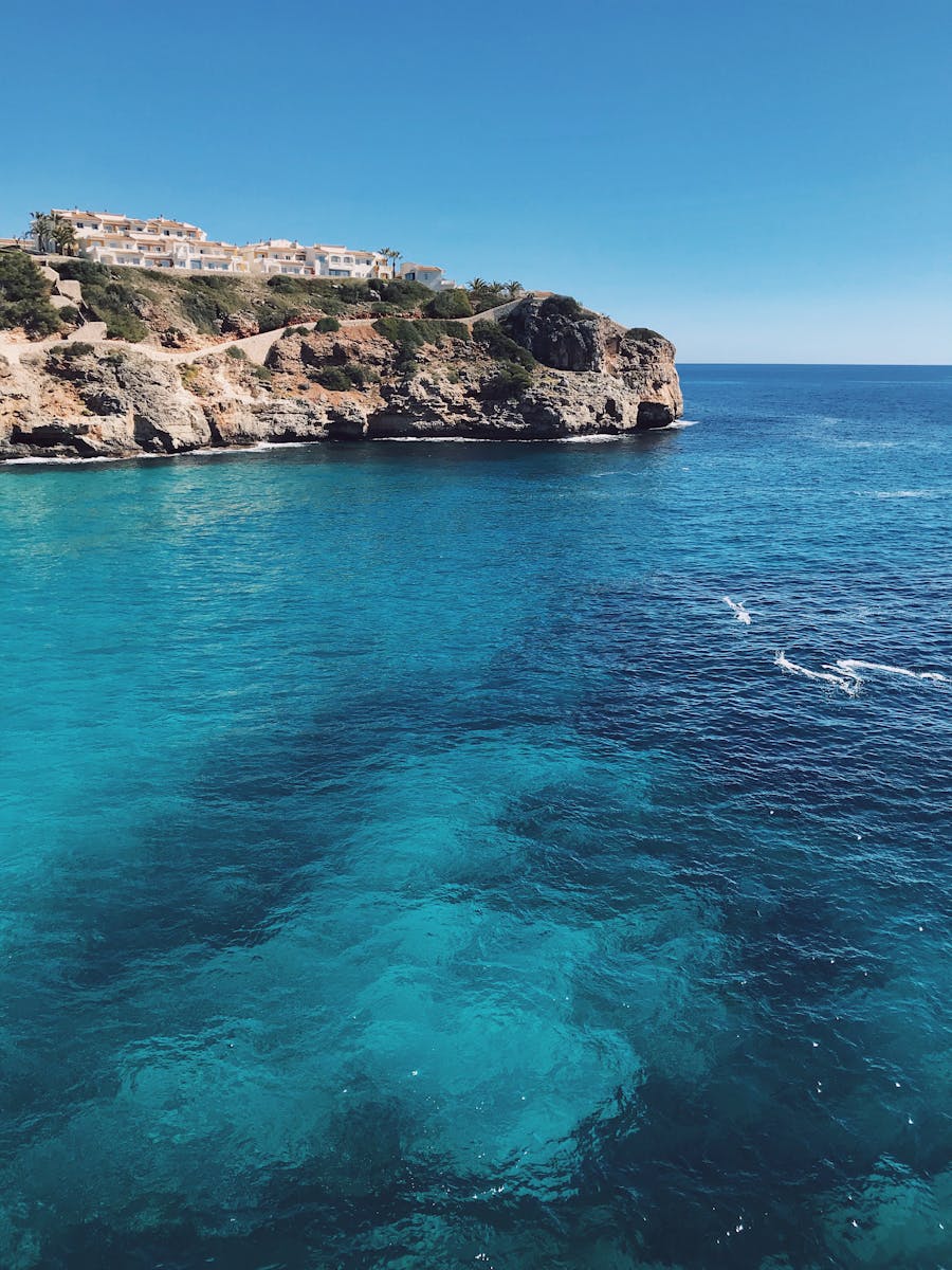 Discover the stunning cliffs and vibrant blue waters of Romàntica, Mallorca, Spain.